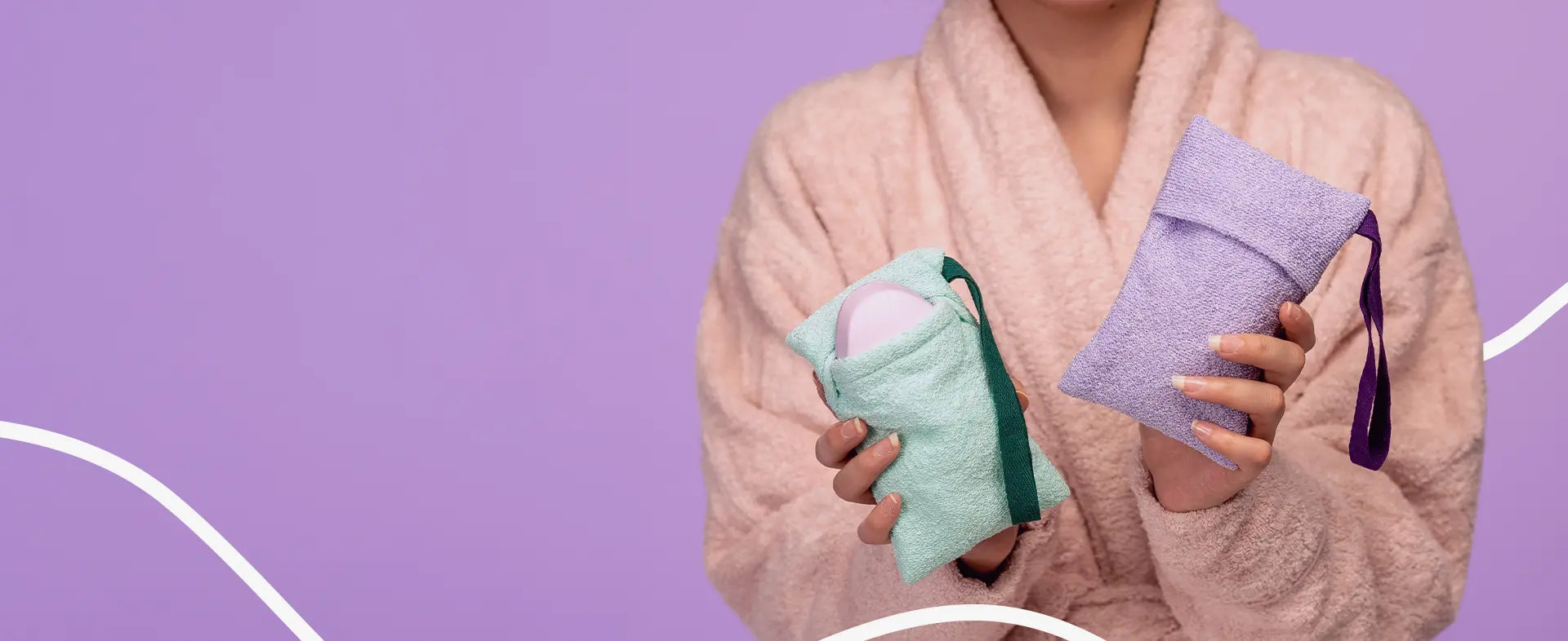 Person in a robe holding two soap savers against a purple background